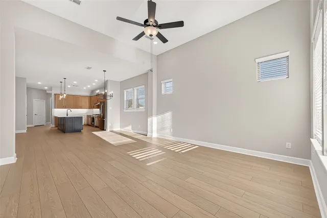 a view of an empty room with a kitchen