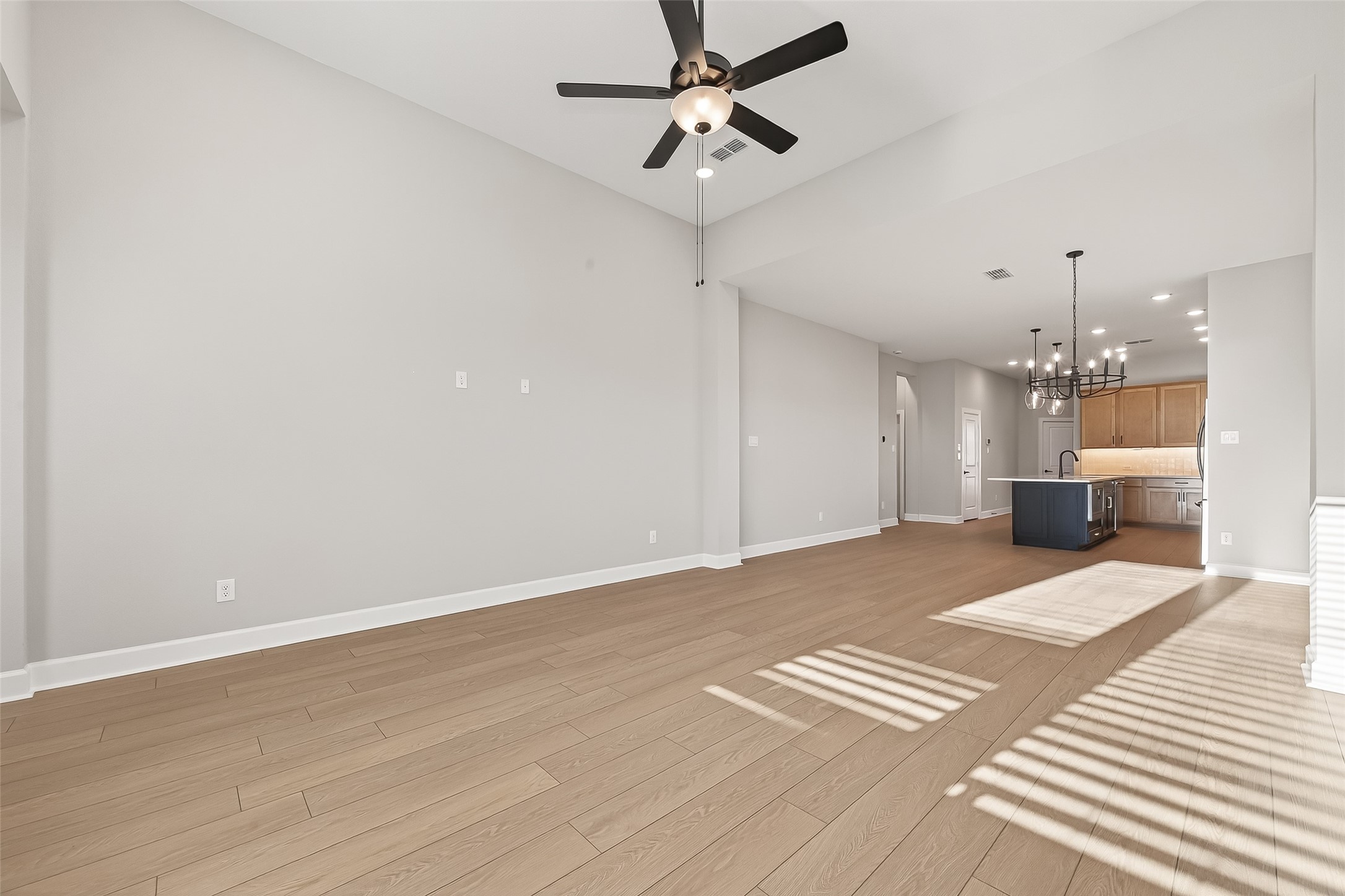 11219 Peacock Flower Street Cypress, TX 77433 - Photo 10 of 50 a view of an empty room with a kitchen