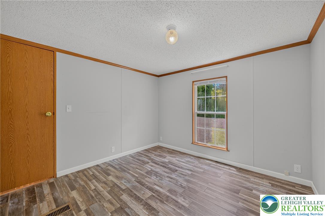 2674 Williams Road Danielsville, PA 18038 - Photo 22 of 31 A quiet retreat with durable plank flooring, awaiting personalized touches.