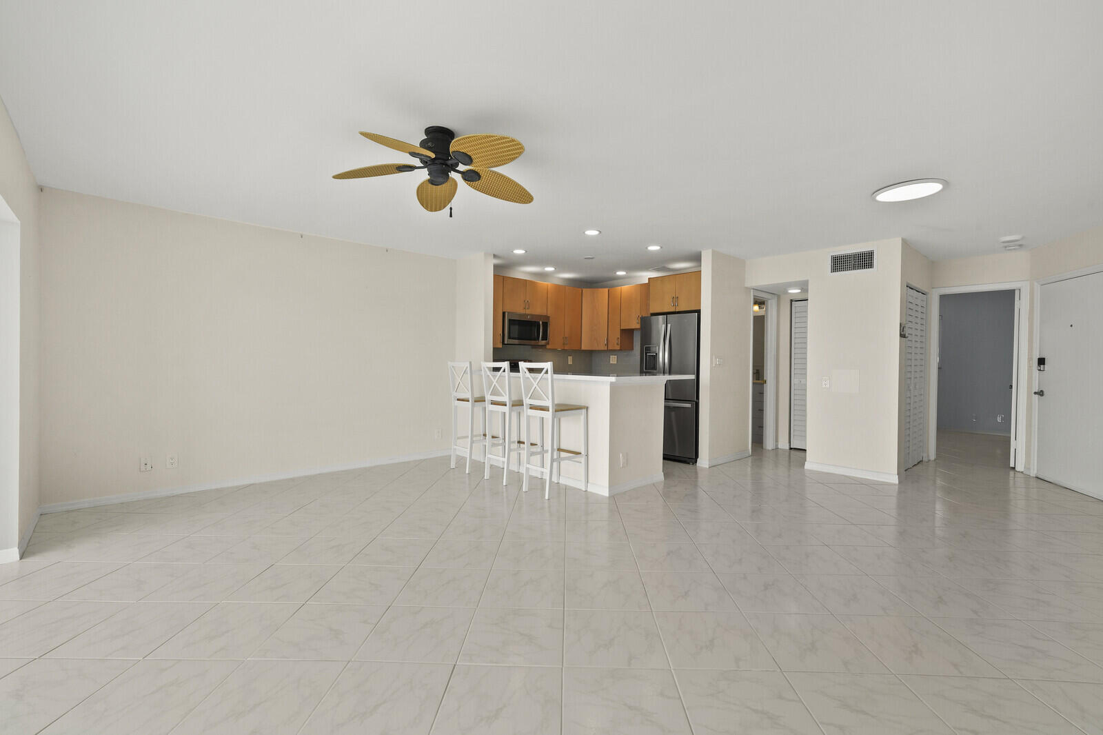 400 Wilma Circle, Unit 207 Riviera Beach, FL 33404 - Photo 14 of 26 a view of kitchen with a refrigerator a microwave and a sink