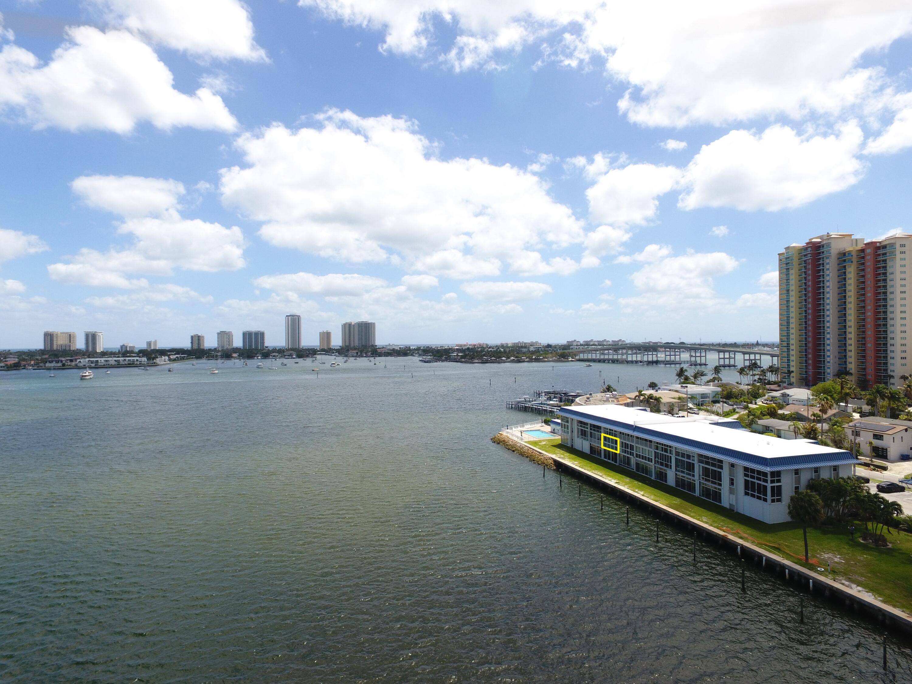 400 Wilma Circle, Unit 207 Riviera Beach, FL 33404 - Photo 2 of 26 a view of a lake with tall buildings