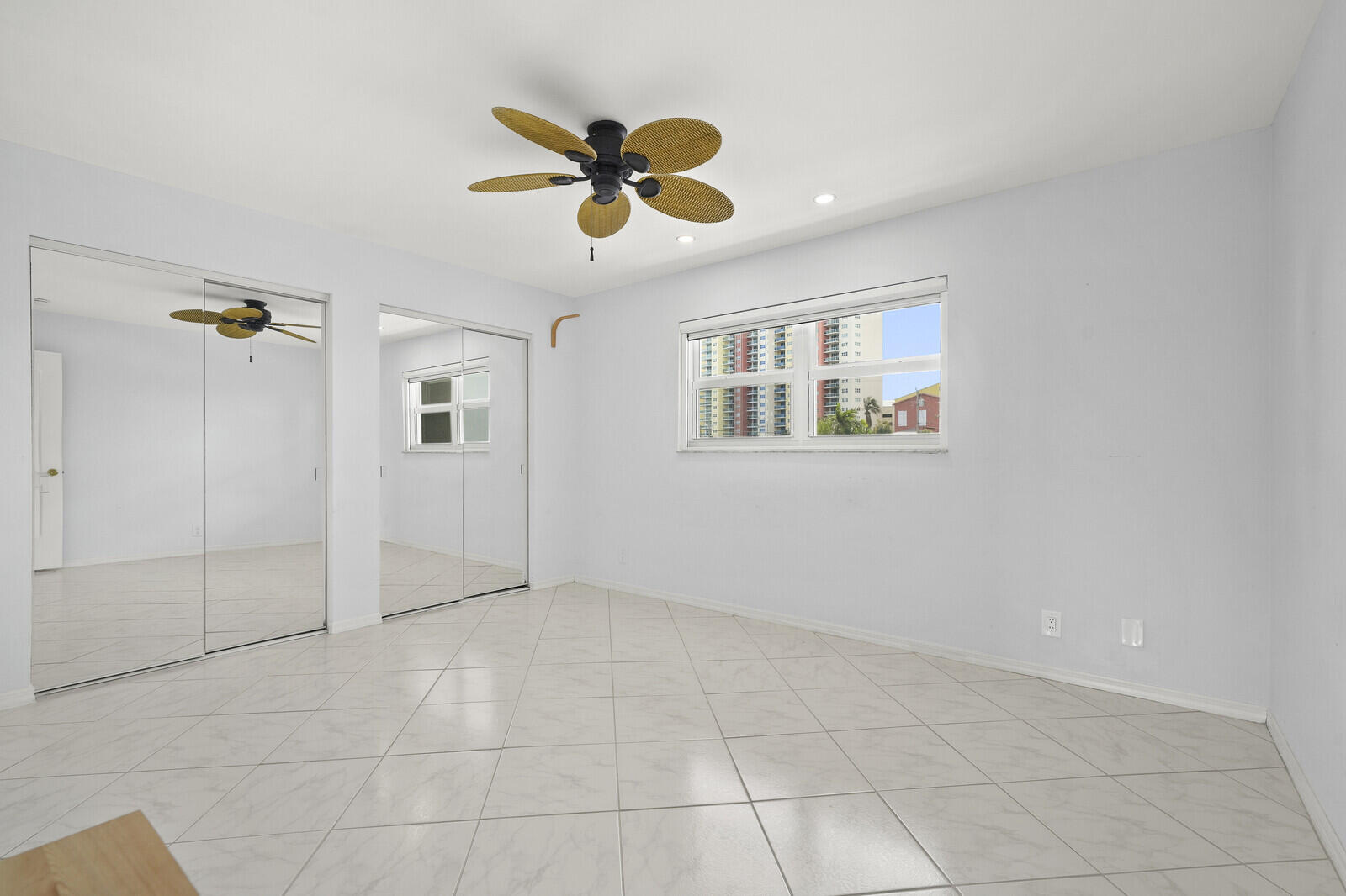 400 Wilma Circle, Unit 207 Riviera Beach, FL 33404 - Photo 22 of 26 an empty room with windows and fan