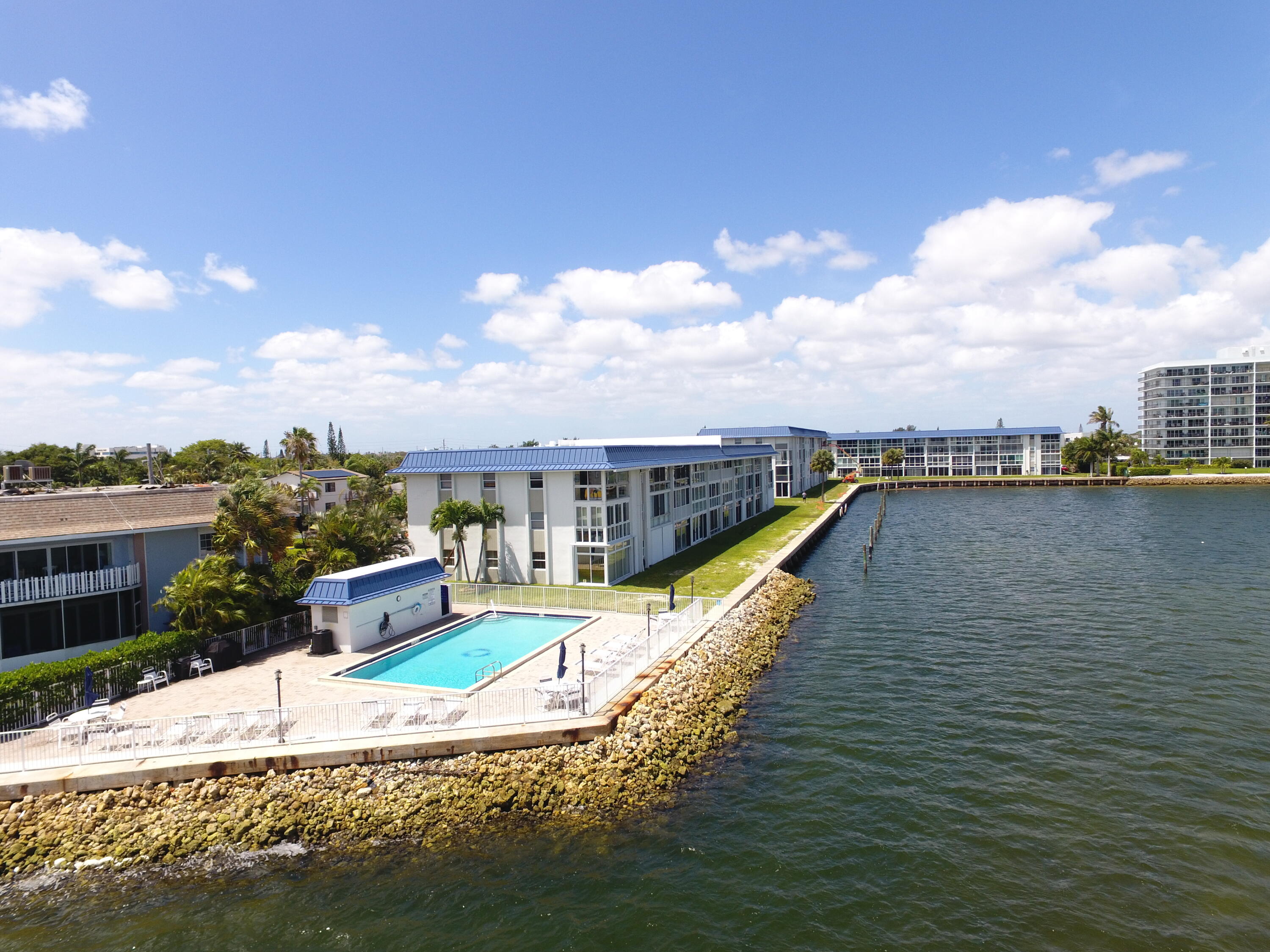 400 Wilma Circle, Unit 207 Riviera Beach, FL 33404 - Photo 24 of 26 a view of a swimming pool and an outdoor seating