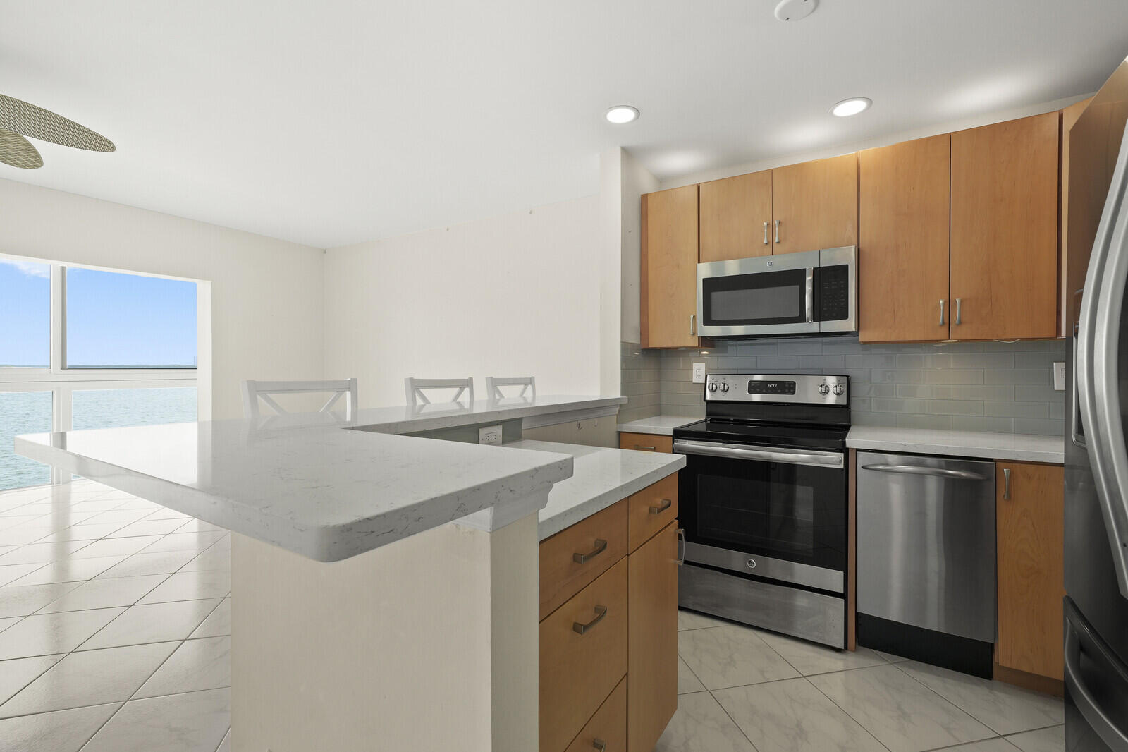 400 Wilma Circle, Unit 207 Riviera Beach, FL 33404 - Photo 9 of 26 a kitchen with stainless steel appliances a stove microwave and sink