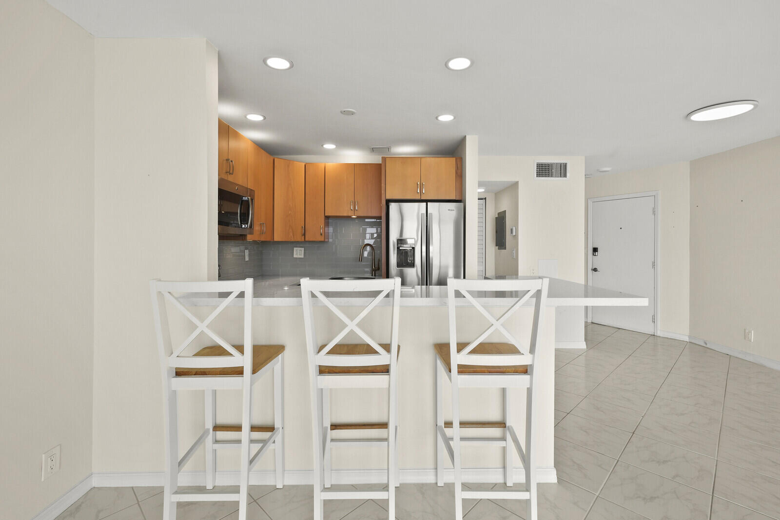 400 Wilma Circle, Unit 207 Riviera Beach, FL 33404 - Photo 10 of 26 a view of a kitchen with table and chairs