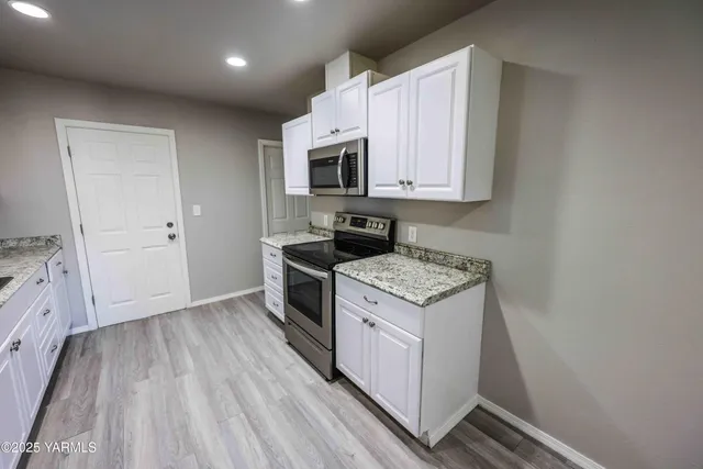 a kitchen with a stove and a microwave