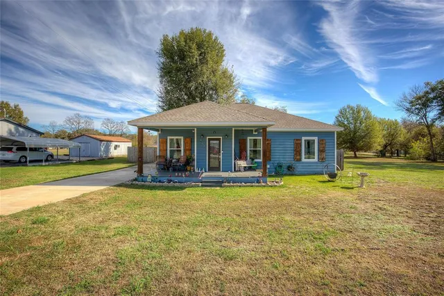 a view of a house with swimming pool and a yard