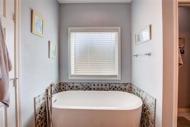 a bathroom with a sink vanity tub and a mirror