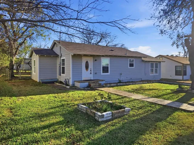 a front view of a house with a yard table and chairs