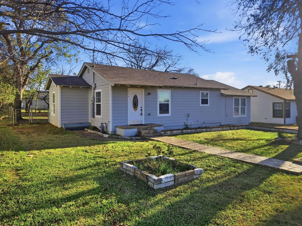 a front view of a house with a yard table and chairs
