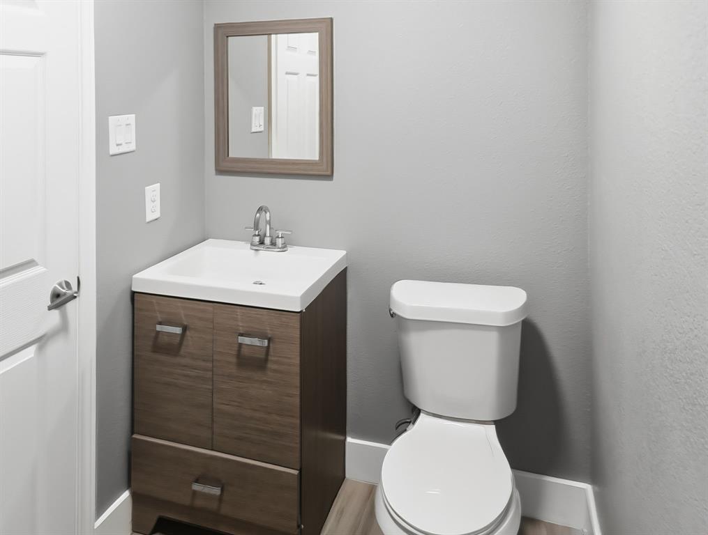 110 Ramsey Street Cleburne, TX 76031 - Photo 18 of 27 a bathroom with a toilet sink and mirror