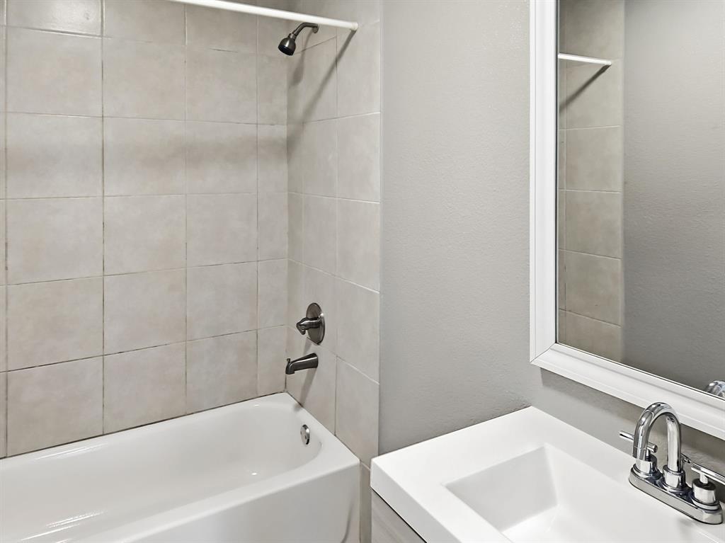 110 Ramsey Street Cleburne, TX 76031 - Photo 21 of 27 a bathroom with a sink and shower