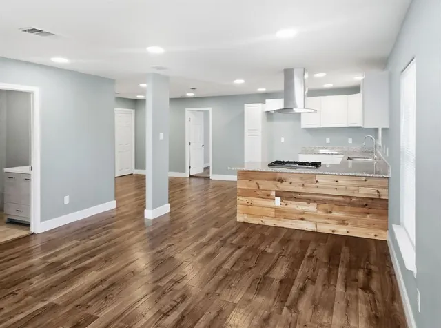 a kitchen with granite countertop a sink stainless steel appliances and cabinets