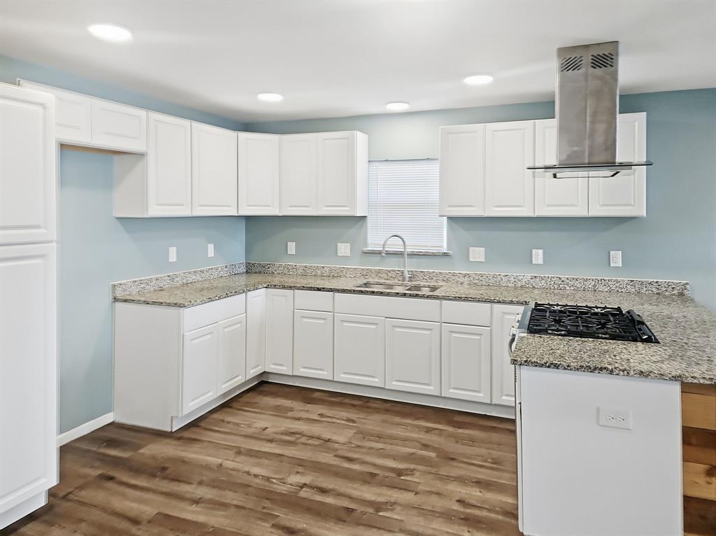110 Ramsey Street Cleburne, TX 76031 - Photo 6 of 27 a kitchen with granite countertop a sink stainless steel appliances and cabinets