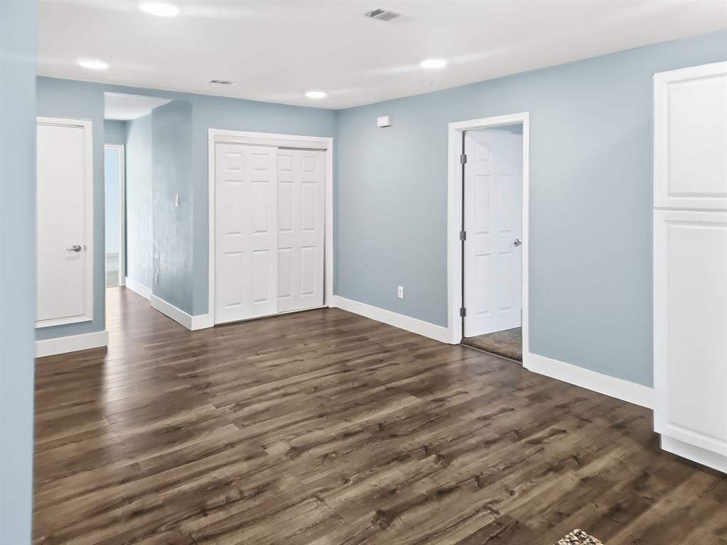 110 Ramsey Street Cleburne, TX 76031 - Photo 9 of 27 a view of an empty room with wooden floor