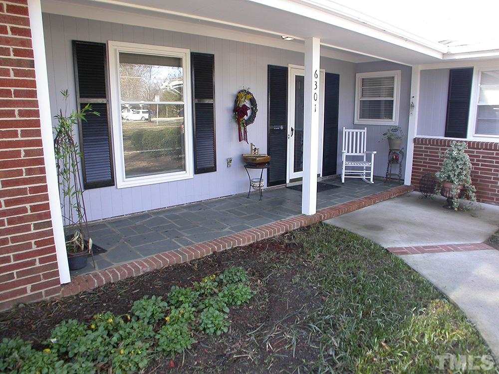 6301 Johnsdale Road Raleigh, NC 27615 - Photo 2 of 25 a front view of a house with a yard