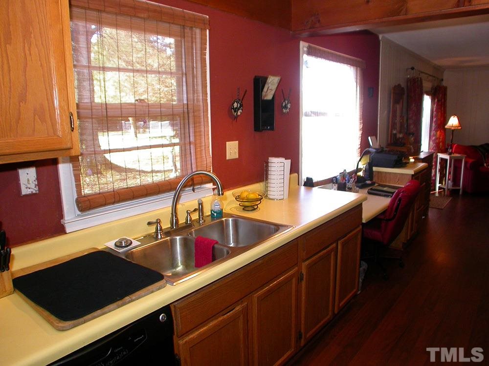 6301 Johnsdale Road Raleigh, NC 27615 - Photo 11 of 25 a kitchen with a sink a counter and cabinets