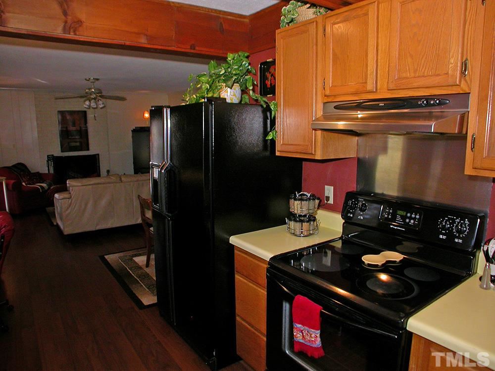 6301 Johnsdale Road Raleigh, NC 27615 - Photo 12 of 25 a kitchen with a stove and a refrigerator