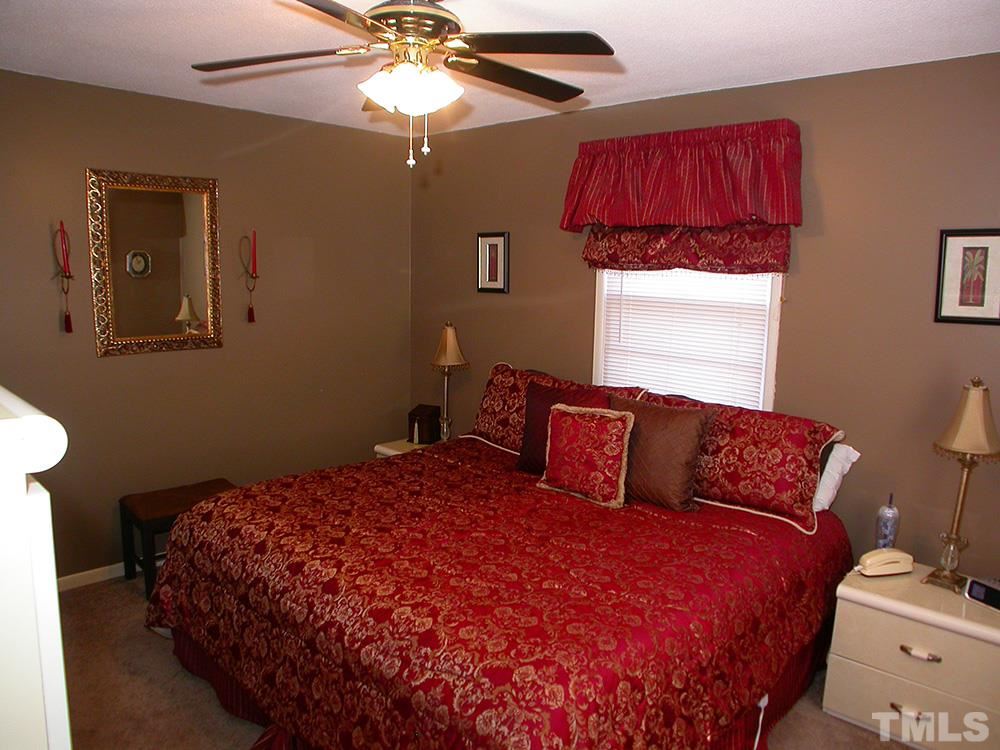 6301 Johnsdale Road Raleigh, NC 27615 - Photo 14 of 25 a bedroom with a bed and a window