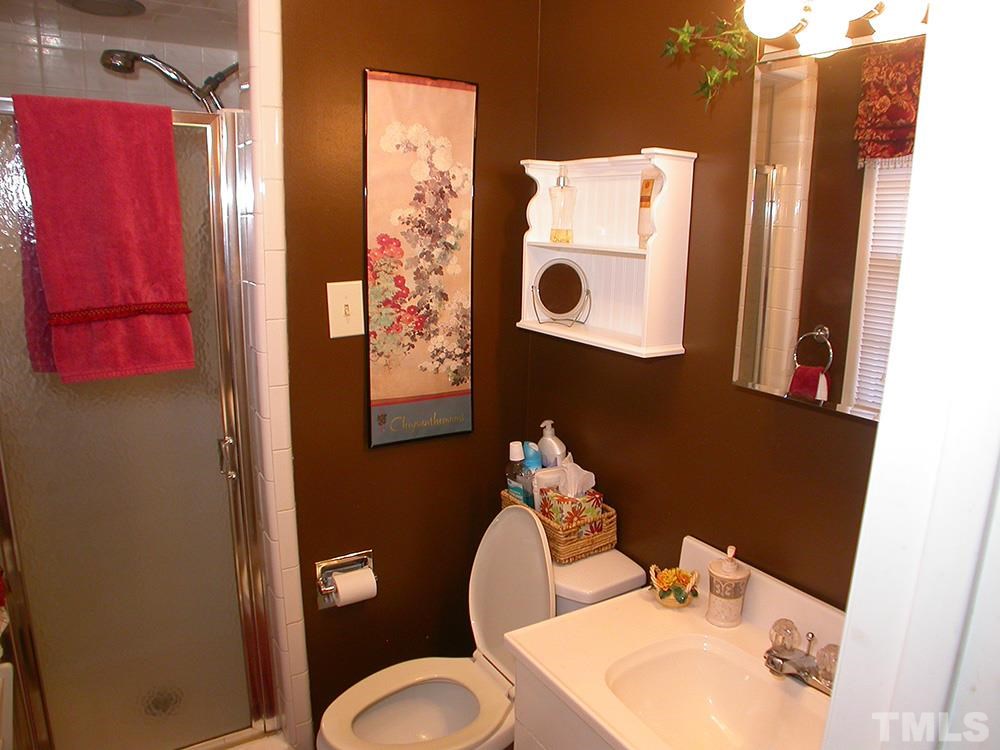 6301 Johnsdale Road Raleigh, NC 27615 - Photo 16 of 25 a bathroom with a sink toilet and mirror