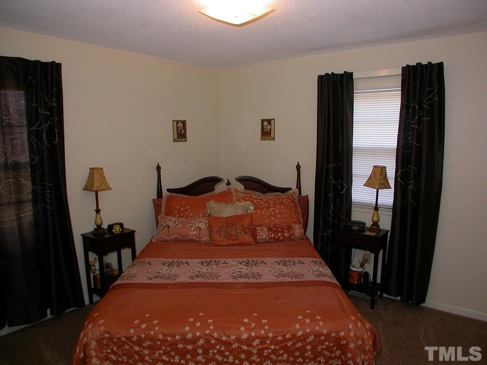 6301 Johnsdale Road Raleigh, NC 27615 - Photo 17 of 25 a large bed sitting in a bedroom next to a window