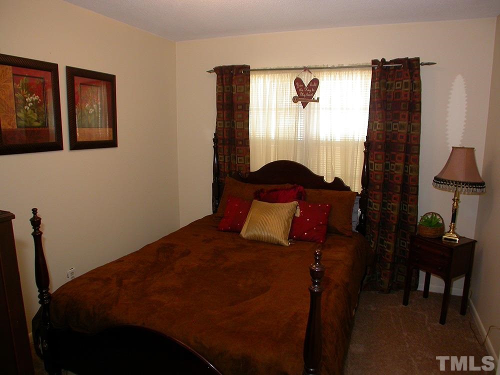 6301 Johnsdale Road Raleigh, NC 27615 - Photo 18 of 25 a bedroom with a bed and a window