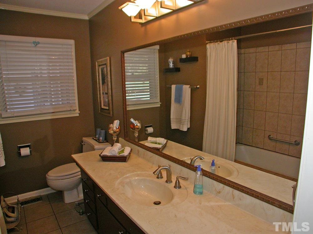 6301 Johnsdale Road Raleigh, NC 27615 - Photo 19 of 25 a bathroom with a sink and a mirror