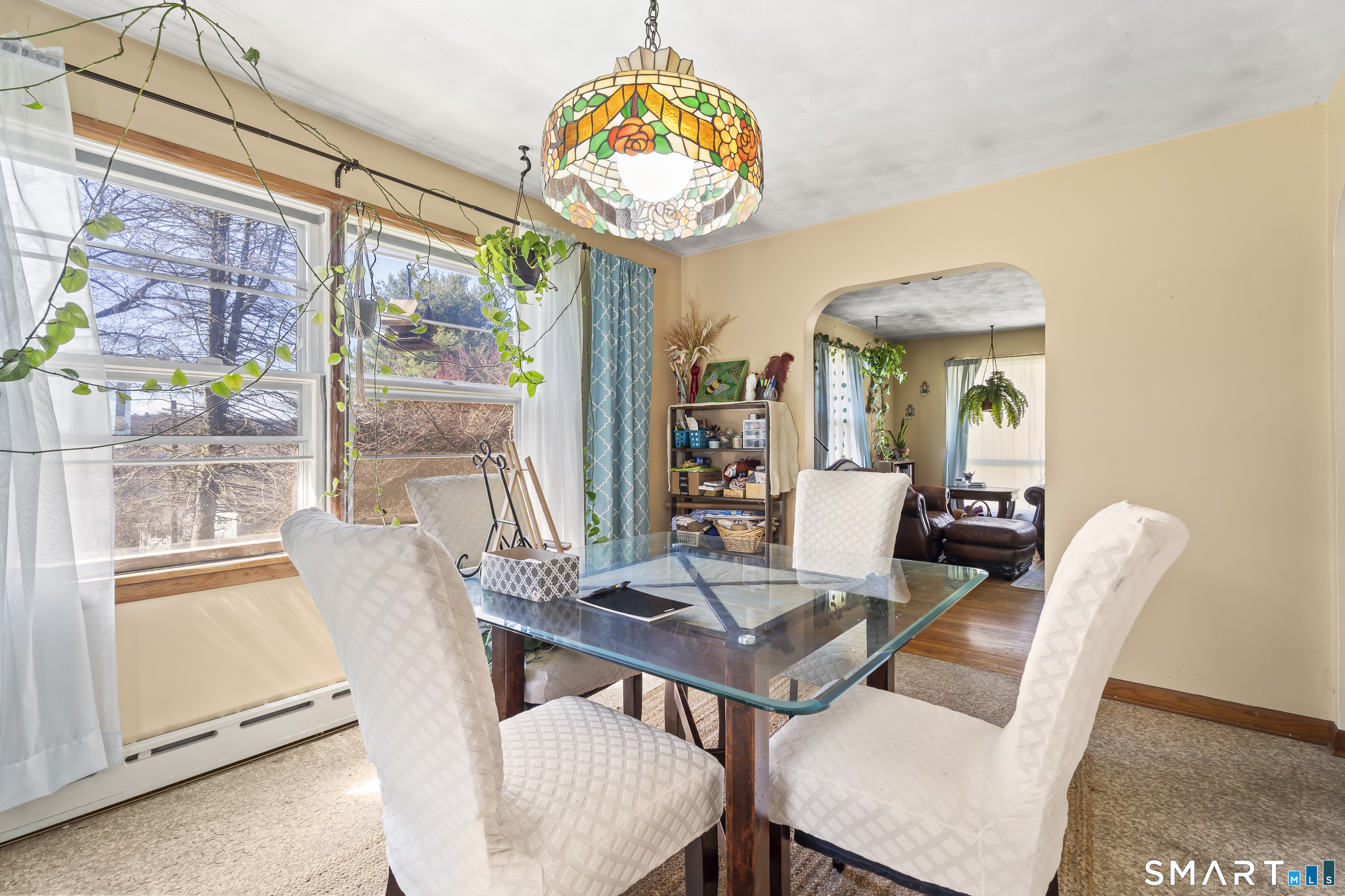 76 Lucas Park Road Norwich, CT 06360 - Photo 12 of 39 a view of a dining room with furniture a chandelier and wooden floor