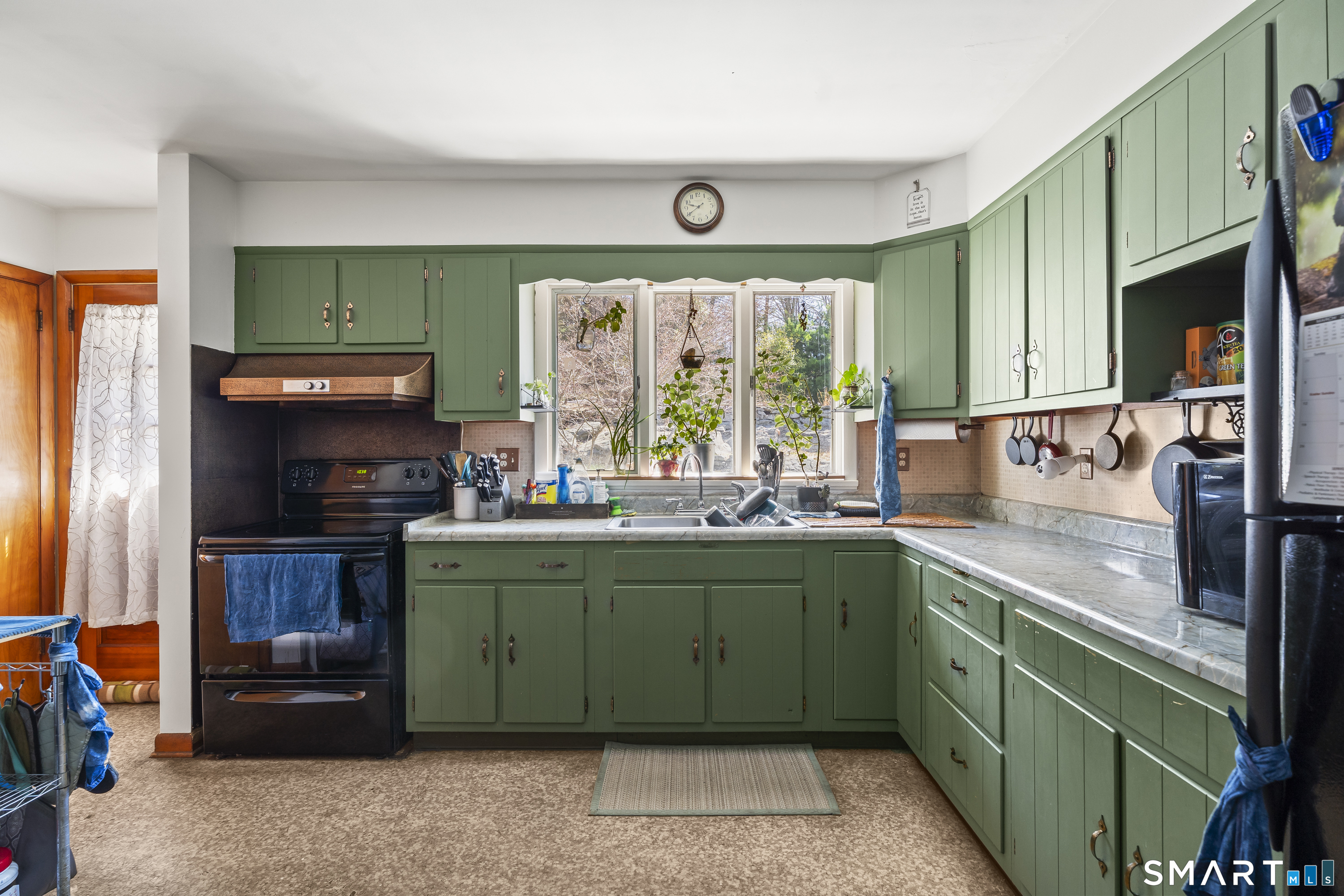 76 Lucas Park Road Norwich, CT 06360 - Photo 14 of 39 a kitchen with a sink and a refrigerator