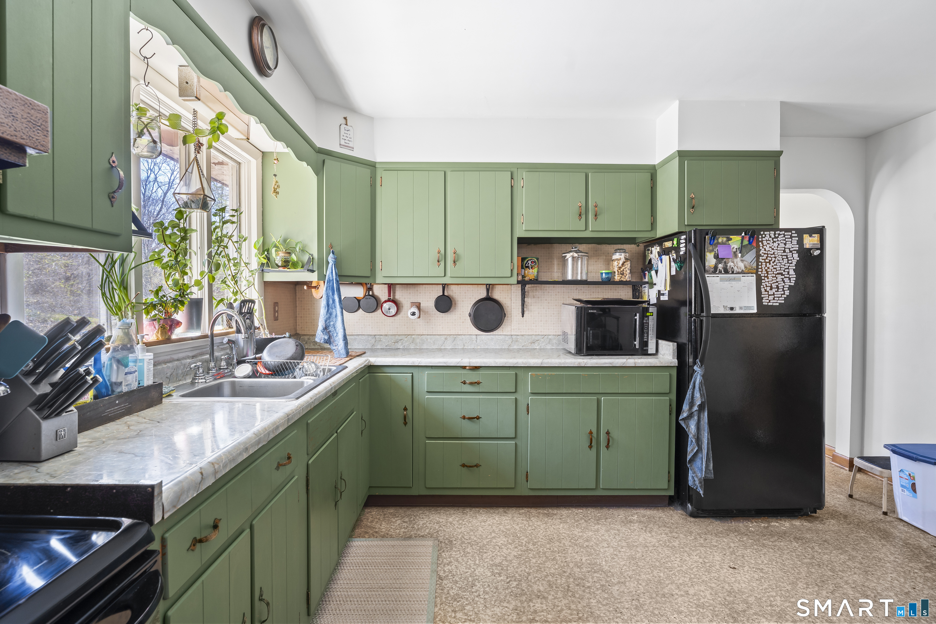 76 Lucas Park Road Norwich, CT 06360 - Photo 16 of 39 a kitchen with green cabinets a sink and a stove