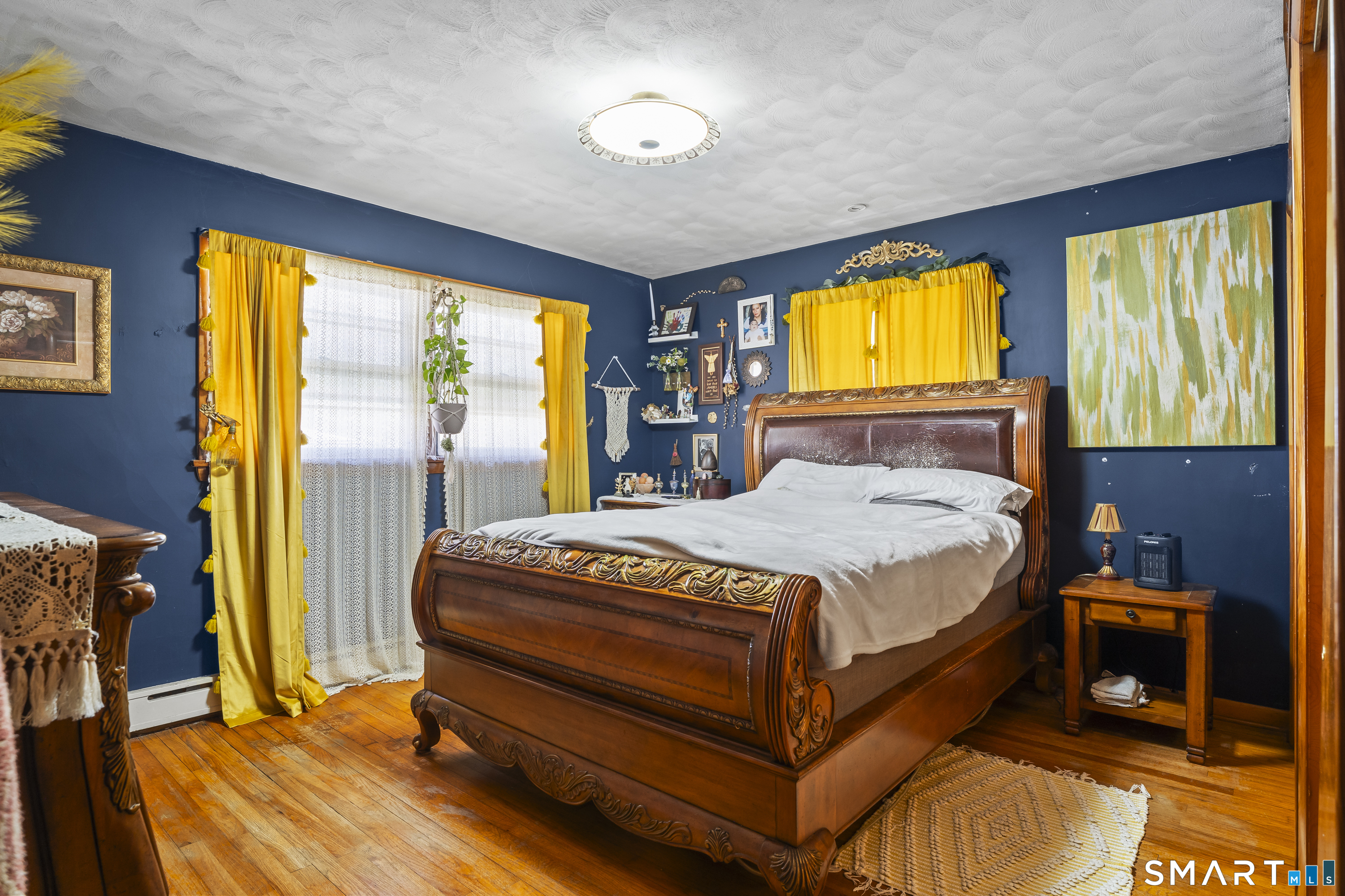 76 Lucas Park Road Norwich, CT 06360 - Photo 23 of 39 a bedroom with a bed and wooden floor