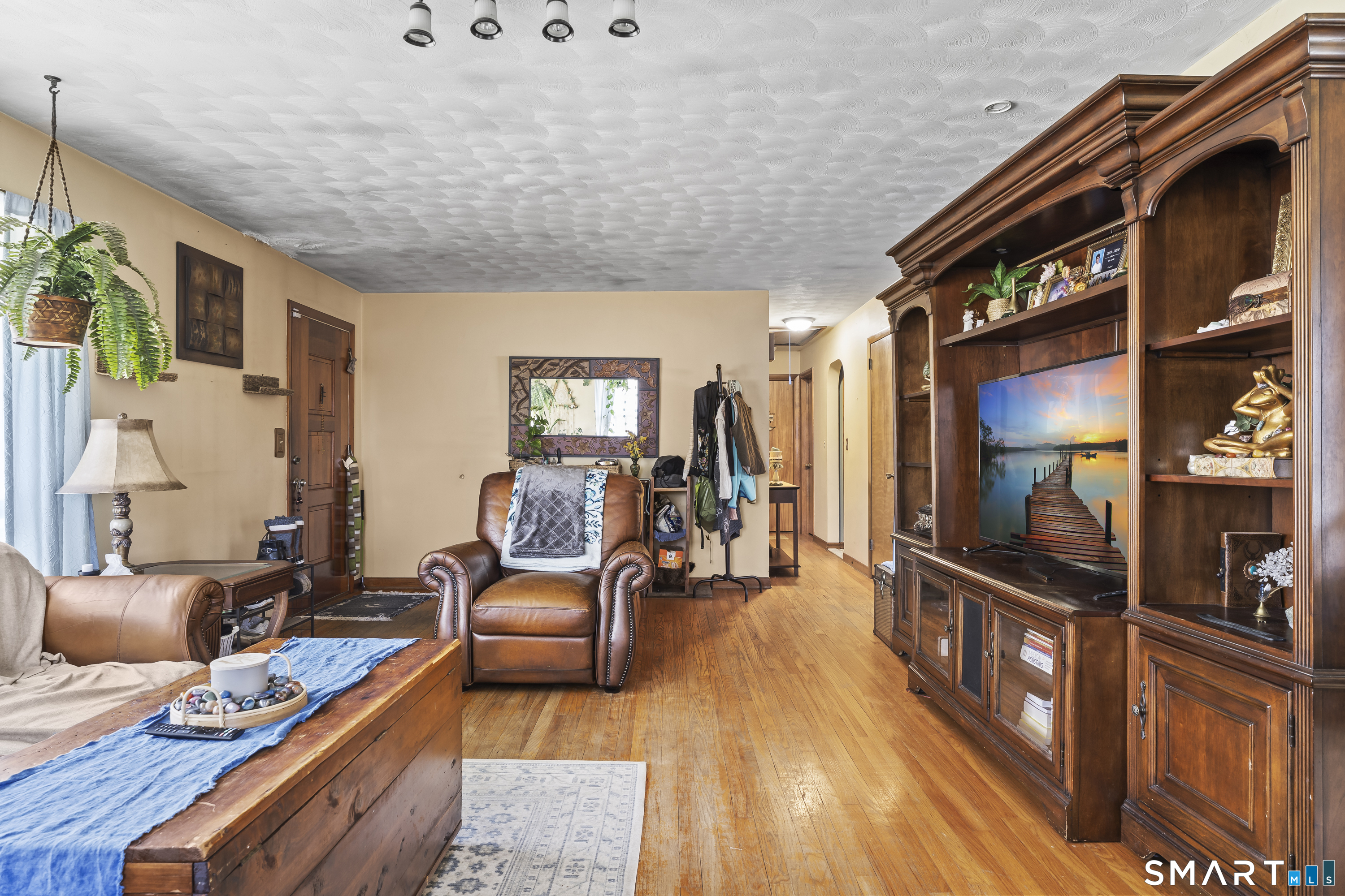 76 Lucas Park Road Norwich, CT 06360 - Photo 10 of 39 a living room with furniture and a flat screen tv