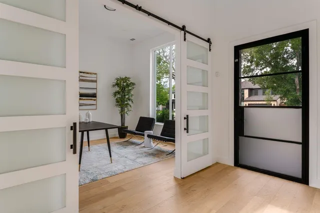 a view of a livingroom with furniture window and wooden floor