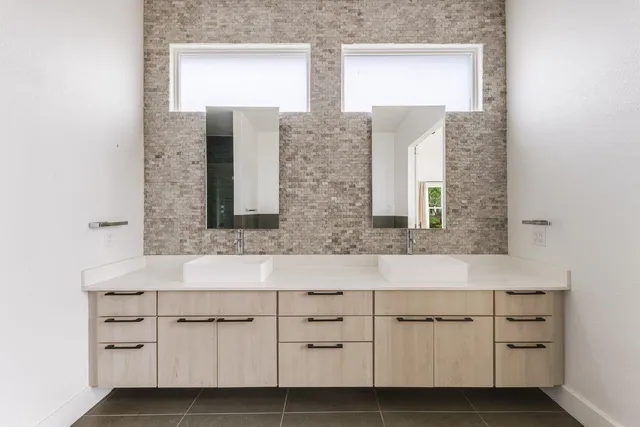 a bathroom with double vanity sink a mirror and