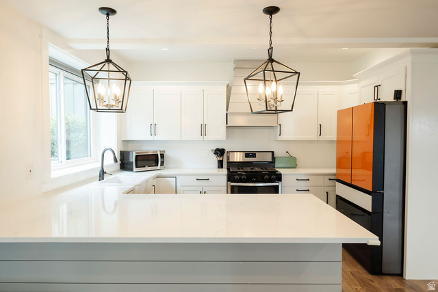 924 Country Lane Farmington, UT 84025 - Photo 52 of 91 Kitchen featuring a large central island with a quartz countertop, white shaker-style cabinetry, stainless steel range, and a shiplap-accented range hood