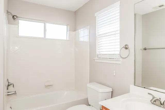 a bathroom with a toilet and a bathtub
