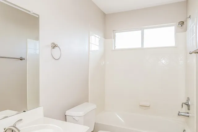 a bathroom with a toilet and a bathtub
