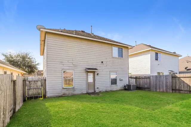 a view of a backyard with wooden fence