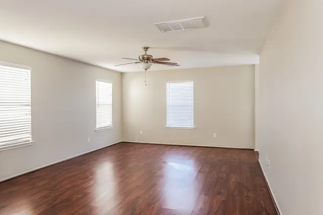 wooden floor in an empty room with a window