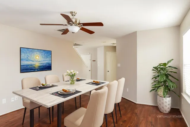 a view of a dining room with furniture wooden floor and chandelier