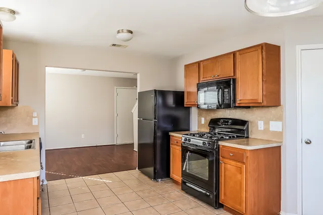 a kitchen with stainless steel appliances a refrigerator a stove a microwave and cabinets