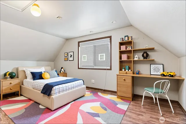 a bedroom with a bed and a table in it