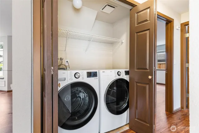 a view of a hallway with washer and dryer