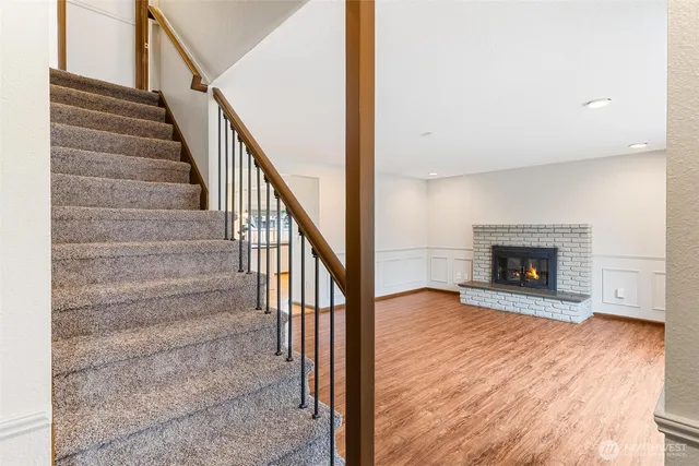 a view of entryway and hall with wooden floor