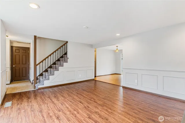 a view of an empty room with wooden floor