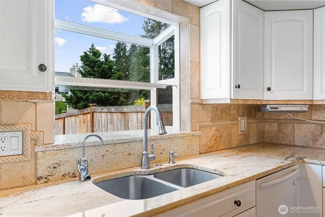 a kitchen with a sink and large window