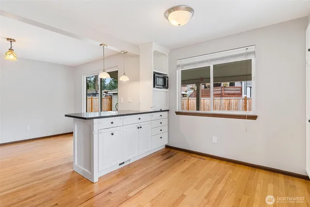 a room with a wooden floor and white walls