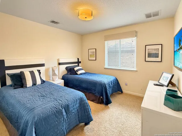 a bedroom with two beds and a couch