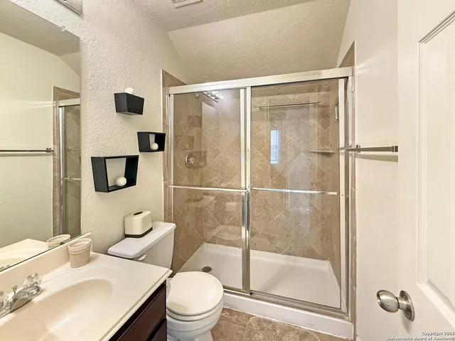 a bathroom with a sink toilet and shower