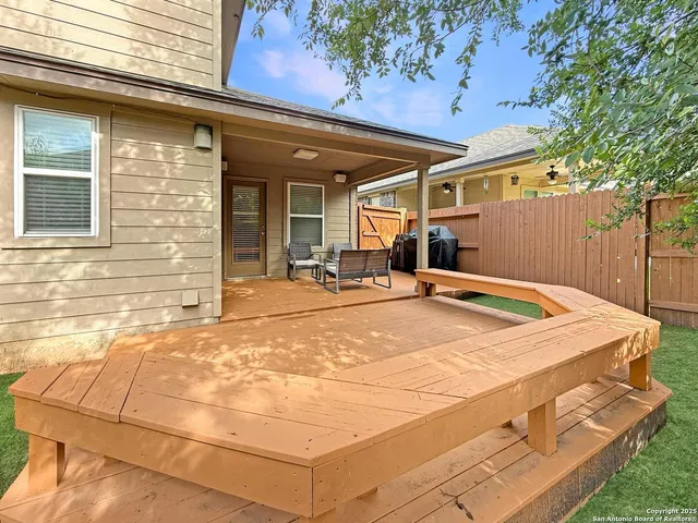 a view of a backyard with a patio and a fountain